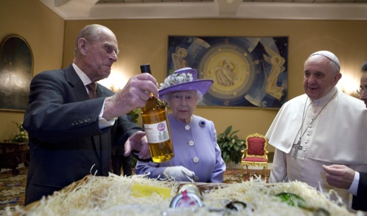 Prince Philip and Britain’s Queen Elizabeth present gifts during meeting with Pope Francis at Vatican